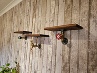 Steampunk wall shelves with industrial pipe fittings and wood tops on rustic wood panel wall