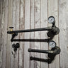 Steampunk industrial pipe wall shelf with pressure gauges and hooks on rustic wood panel