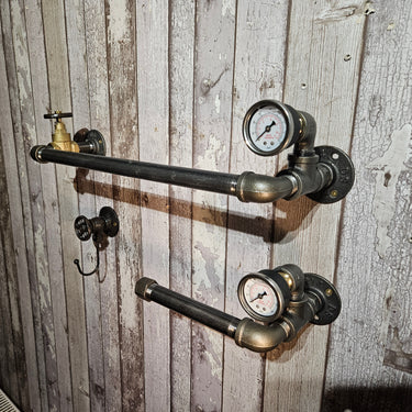 Industrial steampunk pipe shelving with pressure gauge accents on rustic wood wall