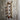 Industrial steampunk copper pipe wall shelf with brass fittings and red valve on rustic wood wall