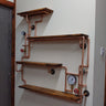 Industrial steampunk wall shelves with copper pipes, wood panels, valves, and gauges