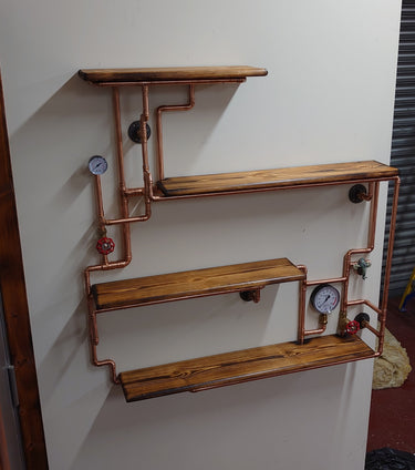 Steampunk industrial wall shelf with copper pipes, vintage gauges, and wooden shelves