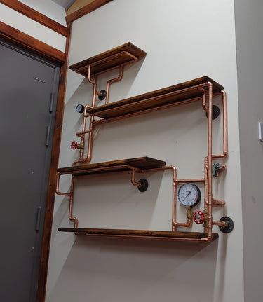 Industrial steampunk wall shelf with copper pipes, wood planks, gauge, and valve accents