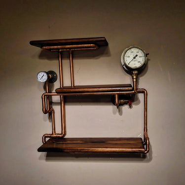 Industrial wall shelf with copper pipes, pressure gauges, and rustic wooden shelves