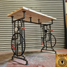 Handmade steampunk industrial table with pipe legs, wheels, chains, and a wood top