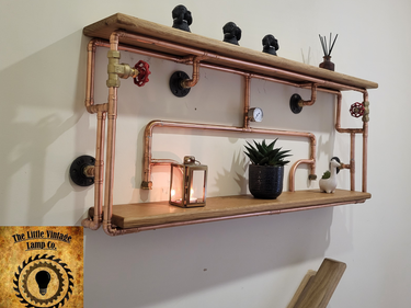 Handmade industrial steampunk wall shelf with copper pipes, wood, and vintage decor accents.