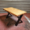 Industrial steampunk coffee table with solid wood top and black cross metal legs