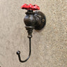 Steampunk industrial wall hook made from metal with a red valve handle accent