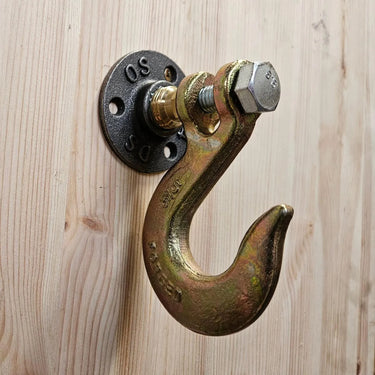 Industrial steampunk wall hook with metal pipe fitting on wood panel
