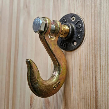 Industrial steampunk metal hook wall hanger on light wood panel