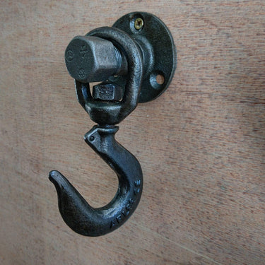 industrial wall-mounted metal coat hook with vintage steampunk design on wood panel