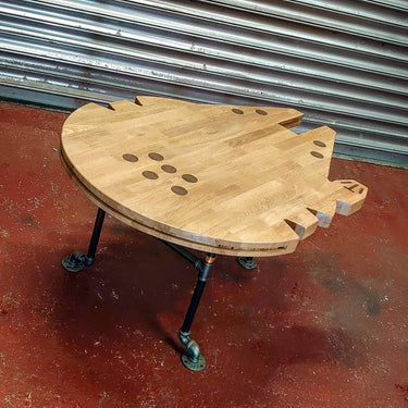 Handmade steampunk coffee table with wood top shaped like a spaceship and industrial metal legs
