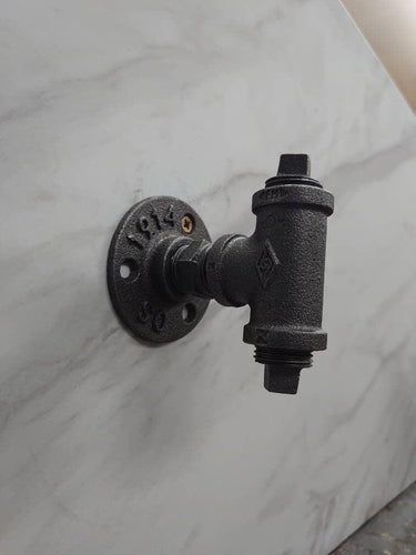 retro industrial rustic metal coat hook on marble wall