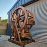 Handmade wooden Ferris wheel style decorative shelf with rustic industrial design outdoors