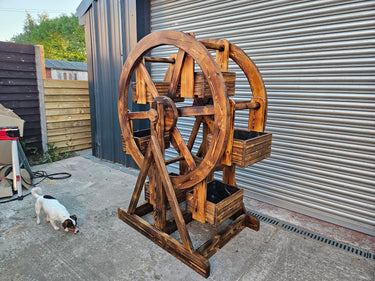 Large handmade wooden Ferris wheel planter with rustic finish, ideal for industrial decor
