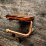 Steampunk copper pipe toilet paper holder with wood shelf on rustic wooden wall