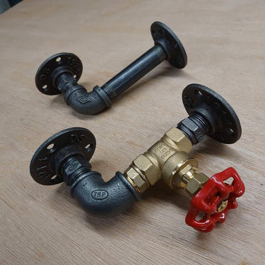 Pair of industrial steampunk pipe wall brackets with metal fittings and red valve handle.