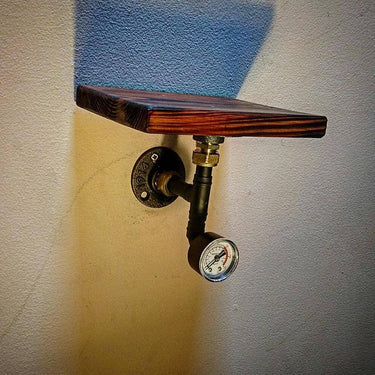 Steampunk single wall shelf with wooden plank and industrial pipe fitting, featuring a pressure gauge accent.