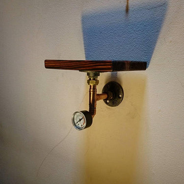 Steampunk single wall shelf with wood plank and metal pipe, featuring a vintage pressure gauge
