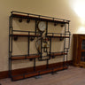 Industrial steampunk shelving unit with black pipe frame, wood shelves, and vintage gauges