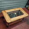 Steampunk coffee table with wooden frame, glass top, visible metal gears, and gauge