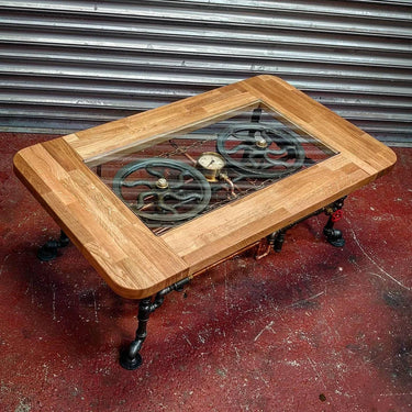 Rectangular steampunk coffee table with wood frame, glass top, and exposed metal gears.