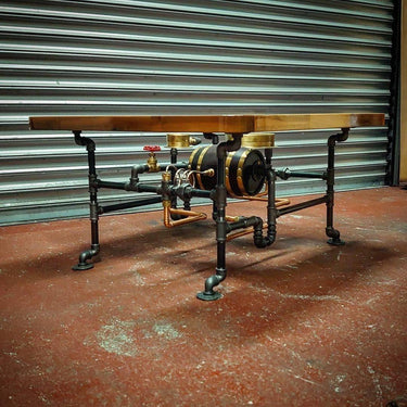 Handcrafted steampunk coffee table with industrial pipes, wood top, and brass accents