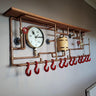 Steampunk industrial coat rack with copper pipes, red hooks, gauge, and wooden shelf