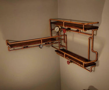 Steampunk shelving unit with copper pipes, pressure gauges, and dark wood shelves mounted on wall.