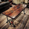 Steampunk coffee table with polished wood top and industrial metal pipe legs in living room