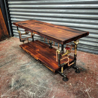 Steampunk coffee table with dark wood shelves and exposed metal pipework, industrial decor style