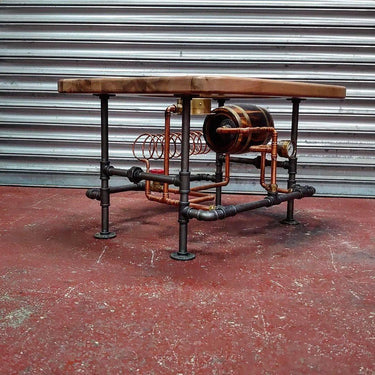 Steampunk coffee table with industrial pipe base, wood top, copper coils and metal accents