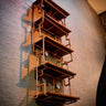 Steampunk wall-mounted shelving unit with wood shelves and industrial copper pipe frame