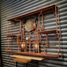 Handmade steampunk shelving unit with copper pipes, wooden shelves, gauges, and industrial lighting.