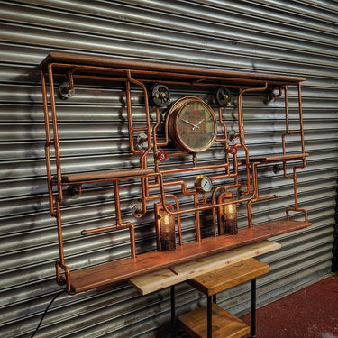 Handmade steampunk shelving unit with copper pipes, vintage gauges, and Edison lights